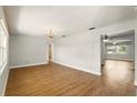 Spacious living room with gleaming hardwood floors and elegant chandelier at 1109 Beatrice Dr, Orlando, FL 32810