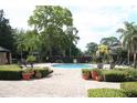 Community pool area featuring cabanas, ample seating and a brick paved sundeck at 1321 Arbor Vista Loop # 325, Lake Mary, FL 32746