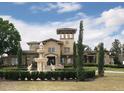 Beautiful building featuring a fountain, manicured lawn, arched windows, and decorative turret at 1321 Arbor Vista Loop # 325, Lake Mary, FL 32746