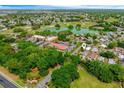 Aerial view of the neighborhood showcasing the home's proximity to lush greenery and a nearby golf course at 1329 Paradise Dr, Lady Lake, FL 32159
