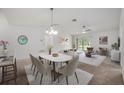 Bright living room with neutral tones, carpeted floors, and an adjacent dining area, ideal for hosting gatherings at 1329 Paradise Dr, Lady Lake, FL 32159
