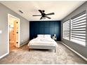 Cozy bedroom with modern accent wall, carpet, large windows and ceiling fan at 14533 Orchid Island Dr, Orlando, FL 32827
