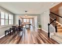 Open-concept living space with hardwood floors, dining area, staircase and kitchen views at 14533 Orchid Island Dr, Orlando, FL 32827