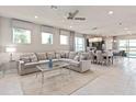 Spacious living room with a large sectional couch, neutral colors, and an open floor plan at 16147 Coastal Cove Ln, Clermont, FL 34714