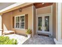 Charming entryway with decorative glass double doors, a tiled porch, and a cozy bench for a welcoming first impression at 1819 Sw 29Th St, Ocala, FL 34471