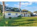 Lovely one-story home featuring a well-kept lawn, palm trees, and a convenient attached garage at 2070 Keyes Ln, Deltona, FL 32738