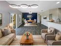 Spacious living room boasts modern lighting, stylish decor, and an open floor plan to the dining area at 2124 Betsy Ross Ln, St Cloud, FL 34769