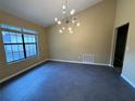 Bright living room featuring vaulted ceilings and modern light fixture at 2132 Majestic Woods Blvd, Apopka, FL 32712
