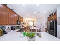 Spacious kitchen featuring white countertops, wood cabinets, stainless steel appliances, and an open layout to the dining area at 2289 Aloe Aly, Apopka, FL 32703