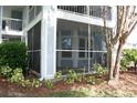Screened patio showcasing an outdoor space, privacy, and a view of the surrounding landscaping at 2593 Grassy Point Dr # 101, Lake Mary, FL 32746