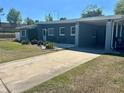 Exterior view of home featuring a long driveway and covered carport at 312 Verbena Dr, Orlando, FL 32807