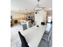 Open concept with modern chandelier, light grey walls, and stylish marble tile floor at 428 Ocean Course Ave, Davenport, FL 33896