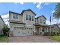 Inviting home with a well-manicured lawn, a brick driveway, and a charming two-car garage at 5144 Ravena E Ave, St Cloud, FL 34771