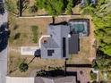 Aerial view of home showcasing backyard pool, patio, and solar panels on the roof at 515 Columbus Ave, Orange City, FL 32763