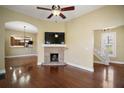 Cozy living room showcasing hardwood floors, a brick fireplace, and ample natural light at 519 N Clara Ave, Deland, FL 32720