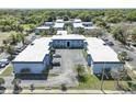 Aerial view of a multi-unit complex, showing its layout, landscaping, and parking areas at 5220 Curry Ford Rd # 303, Orlando, FL 32812