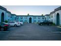 Exterior view of the apartments displaying architectural style, parking area and landscape at 5220 Curry Ford Rd # 303, Orlando, FL 32812