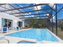 A refreshing screened-in pool with outdoor seating, perfect for relaxation and entertainment at 5502 Willow Bend Trl, Kissimmee, FL 34758