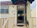 Welcoming entryway with a decorative awning, and a view into the bright living area at 6104 Topher Trl # 6104, Mulberry, FL 33860