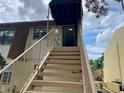 Exterior view of the staircase leading to the condo's entrance, with a protective awning above at 6104 Topher Trl # 6104, Mulberry, FL 33860