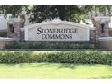 Entrance sign for Stonebridge Commons with manicured landscaping and brick pillars at 6453 Alcalde Ct # 104, Orlando, FL 32835