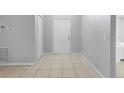 Clean entryway with neutral tile flooring and a white front door and coat closet at 6749 Westlake Blvd, Orlando, FL 32810