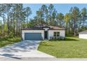 Charming single-story home featuring a well-manicured lawn and a convenient attached two-car garage at 7110 Sw 134Th St, Ocala, FL 34473