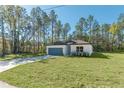 Charming single-story home featuring a well-manicured lawn and a convenient attached two-car garage at 7110 Sw 134Th St, Ocala, FL 34473