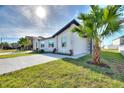 Side view of home boasting fresh landscaping, lush grass, and a long, new driveway at 804 Colville Dr, Kissimmee, FL 34759