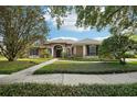 Charming single-story home with manicured lawn and mature trees in a desirable neighborhood at 859 Windcrest Pl, Winter Springs, FL 32708