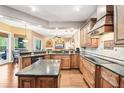Well-appointed kitchen with a central island, granite countertops, and custom cabinetry at 859 Windcrest Pl, Winter Springs, FL 32708