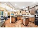 Spacious kitchen with dark wood cabinets, granite countertops, and stainless steel appliances at 859 Windcrest Pl, Winter Springs, FL 32708