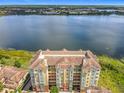 Stunning aerial view of a waterfront condominium with a tile roof and beautiful lake views at 8743 S The Esplanade # 18, Orlando, FL 32836
