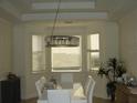Modern dining room with a unique chandelier and ample natural light at 8743 S The Esplanade # 18, Orlando, FL 32836