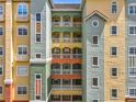 Detailed shot of a colorful condo building showcasing balconies and architectural design at 8743 S The Esplanade # 18, Orlando, FL 32836