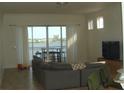Bright living room with couch, balcony, and water view at 8743 S The Esplanade # 18, Orlando, FL 32836