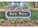 Key West Condominium community sign surrounded by lush green bushes at 980 Mooring Ave # 105, Altamonte Springs, FL 32714