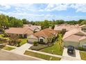 Single-story home with a tile roof in a quiet neighborhood has mature landscaping and a paver driveway at 618 Via Milano, Apopka, FL 32712