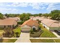 Lovely single-story home boasts mature landscaping and a paver driveway in a quiet neighborhood at 618 Via Milano, Apopka, FL 32712
