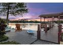 Beautiful lake view from a dock, complete with Adirondack chairs and a paddleboard at 7849 Georgeann St, Winter Park, FL 32792