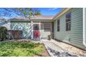 Charming home with a red door, screened front porch, well-maintained lawn, and pretty landscaping at 840 Cortez Ave, The Villages, FL 32159