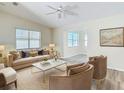 Bright living room featuring a plush sofa, marble coffee table, and comfortable seating, creating an inviting atmosphere at 840 Cortez Ave, The Villages, FL 32159