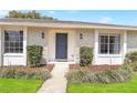 Home's attractive blue front door framed by decorative stone, plants, and modern sconces adds curb appeal at 1011 Terry Dr, Altamonte Springs, FL 32714