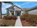Inviting home exterior with a manicured lawn and a walkway leading to the front door at 1028 Marietta Ln, Eustis, FL 32726