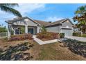 Charming single-story home featuring a well-manicured lawn and mature landscaping at 1028 Marietta Ln, Eustis, FL 32726