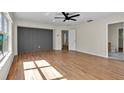 Spacious bedroom with wood floors, a ceiling fan, and an ensuite bathroom at 1037 Sailing Bay Dr, Clermont, FL 34711