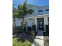 Charming two-story townhome featuring a modern facade and lush landscaping at 1188 Challenge Dr, Davenport, FL 33896