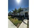 Inviting townhome showcasing modern architecture, well-kept lawn, and landscaped walkway at 1188 Challenge Dr, Davenport, FL 33896
