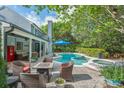 Inviting backyard featuring a pool, spa, covered patio with cozy furniture and outdoor seating at 1311 Olympia Park Cir, Ocoee, FL 34761
