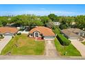 An aerial view showcases this lovely property, its green lawn, and surrounding neighborhood at 1330 Broken Pine Rd, Deltona, FL 32725